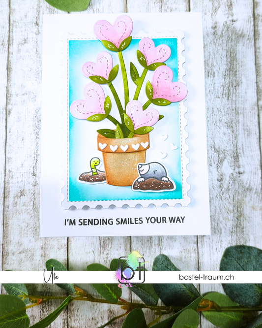 Beispielkarte A Mole lot of love mit einer Topfpflanze mit Herzblüten, Maulwurf und Wurm.